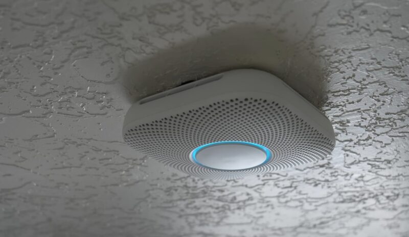 A modern smoke detector, discreetly mounted to the ceiling